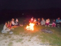 Singing by the campfire while the potatoe is being baked.