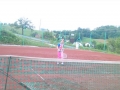 Playing tennis.